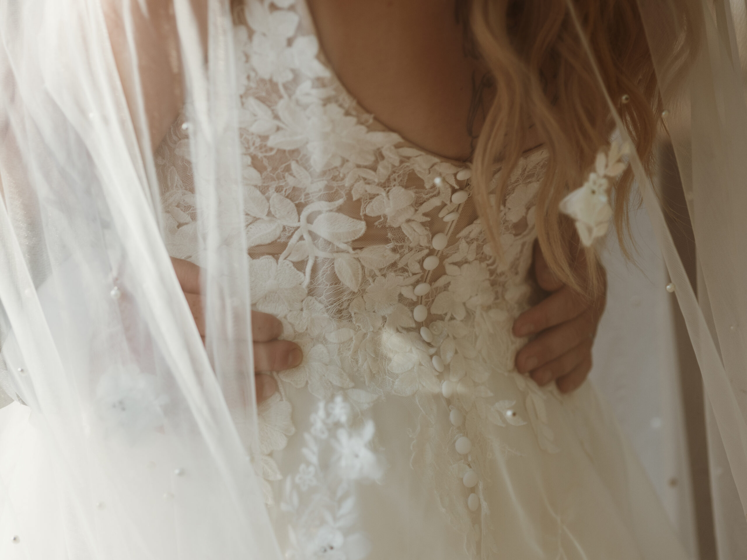 Bride holding baby's breath wedding bouquet